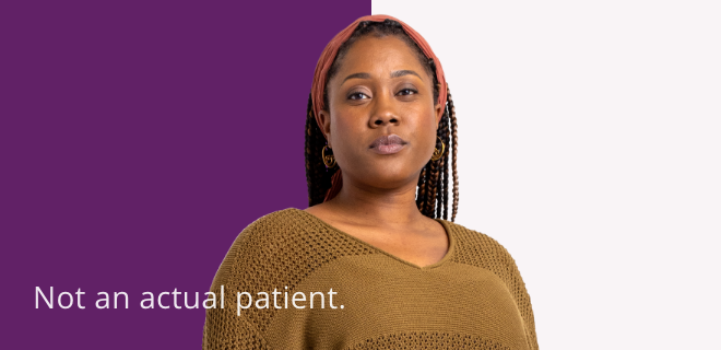 A confident, young Black woman standing looking forward. Not an actual patient.